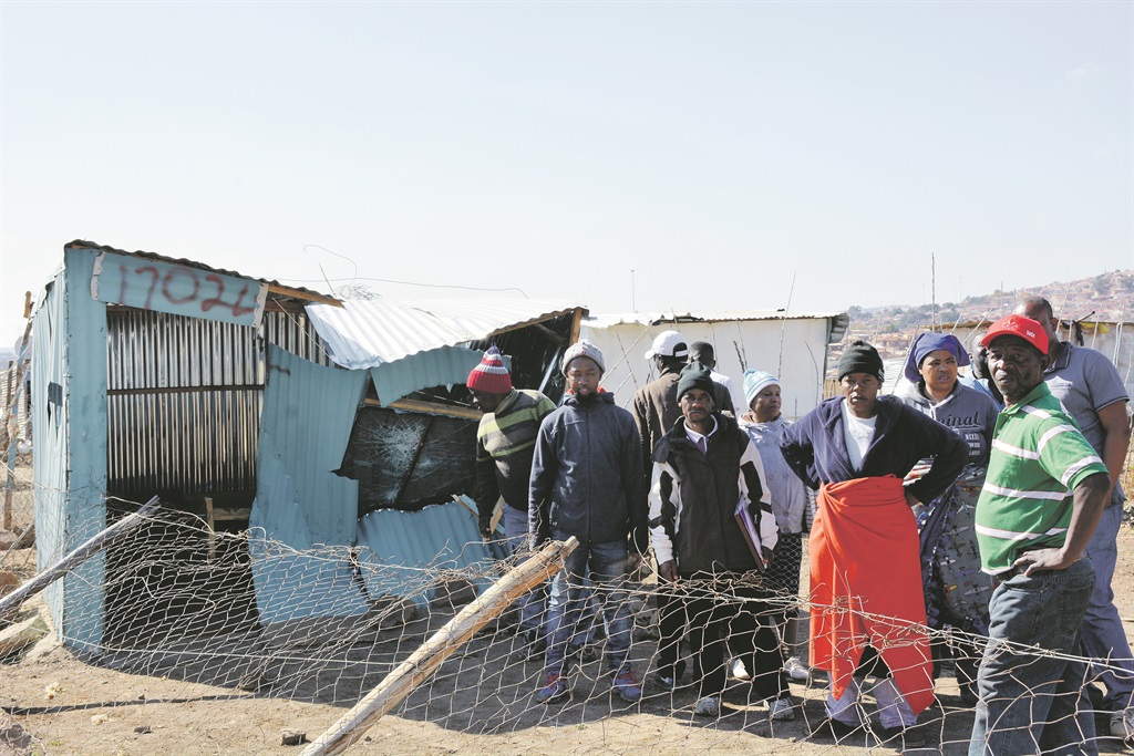 Tsunami residents knocked down a shack in their area after their illegal connections were cut.