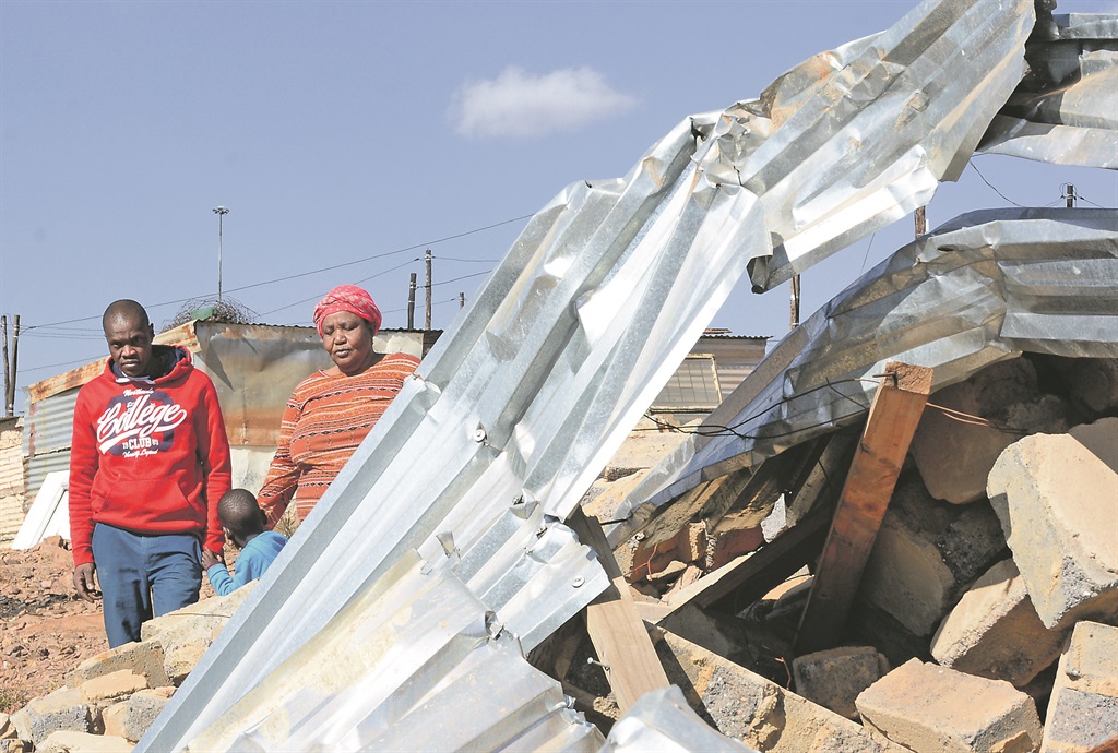 Alfred Mhlala and his wife Constance Mohlala stand near the rubble left behind by the Red Ants in December when they demolished their house.      Photo by Morapedi Mashashe