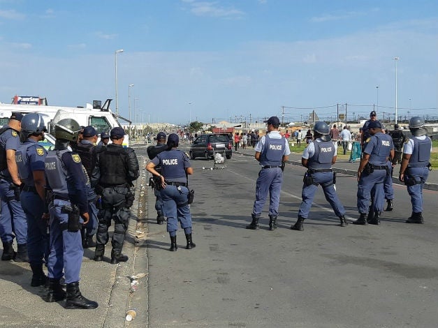 Police keep a watchful eye on protesters in Zwelihle, Hermanus. (Jenni Evans/News24)