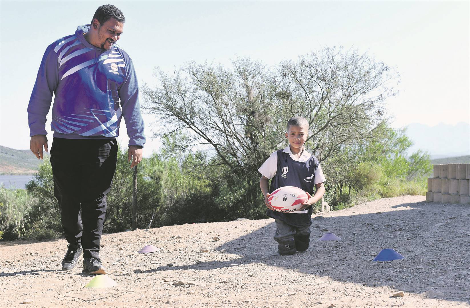 Grayton Rhode, from Stockwell NGK Primary School outside Ashton, lost his legs when he was three. He is seen here with his coach Gaewinne Niemand.