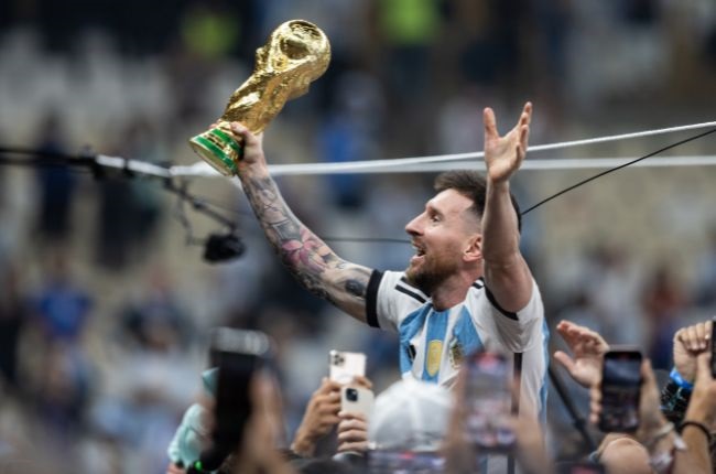 Lionel Messi holds the World Cup trophy. (Photo by Simon Bruty/Anychance/Getty Images)