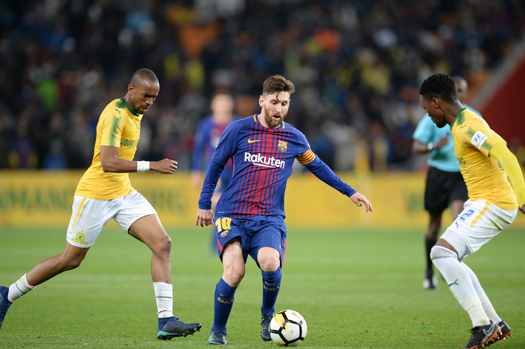 Barcelonas Argentine soccer star Lionel Messi and Tiyani Mabunda of Mamelodi Sundowns.