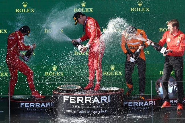 Ferrari duo in race winner Carlos Sainz and second-placed Charles Leclerc celebrate alongside McLaren's Lando Norris, who finished third in the Australian Grand Prix at Albert Park Circuit in Melbourne on Sunday. (Robert Cianflone/Getty Images)
