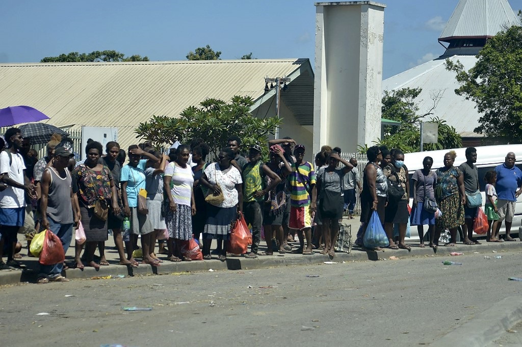 Residents stay in the open in downtown Honiara on 22 November as people rushed from their offices and fled to higher ground after a strong earthquake.