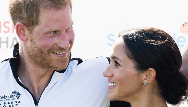 Harry and Meghan smiling. 