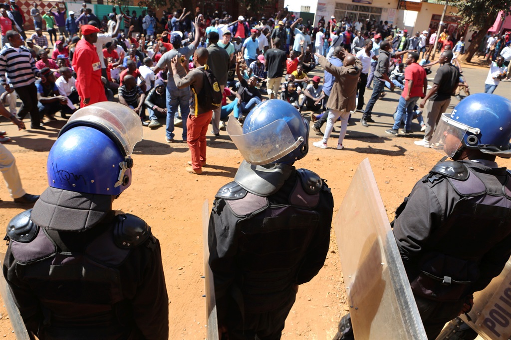Police block dozens of opposition party supporters from entering the Zimbabwe Electoral Commission offices in Harare on Wednesday (August 1, 2018). Zimbabwe’s ruling party has won a majority of seats in Parliament, the electoral commission announced Wednesday, as the country braced for the first official results of the presidential election. Picture: Tsvangirayi Mukwazhi/AP