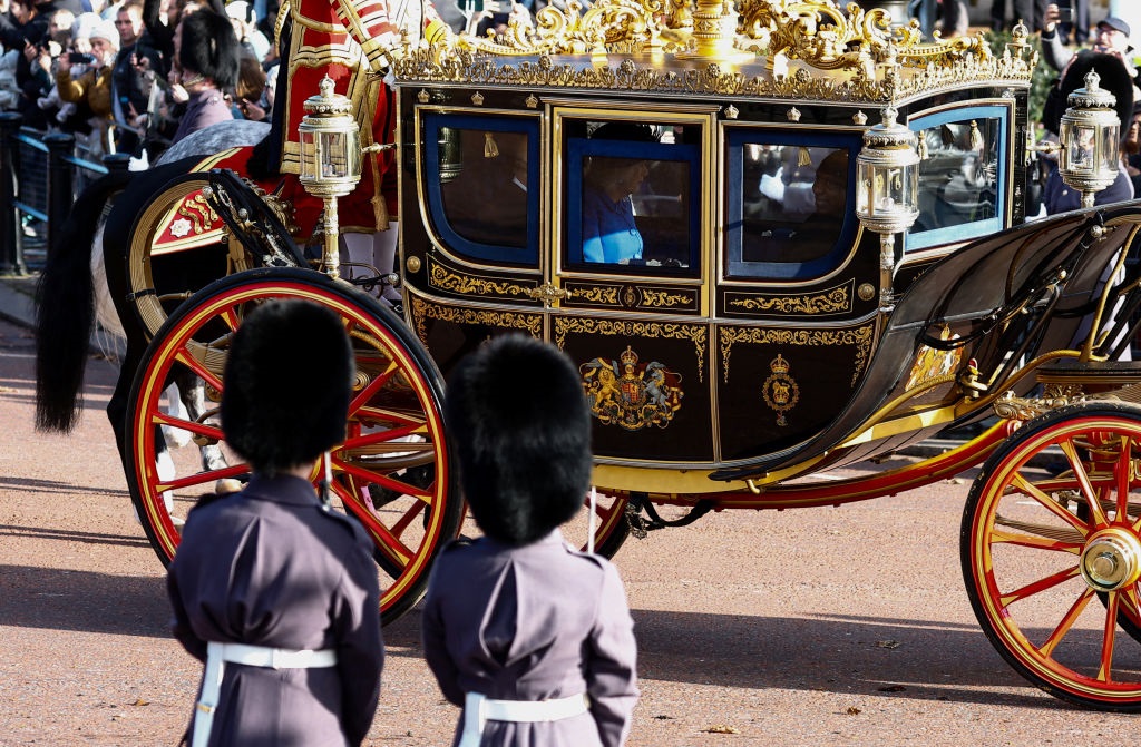 A procession leading a state carriage containing B