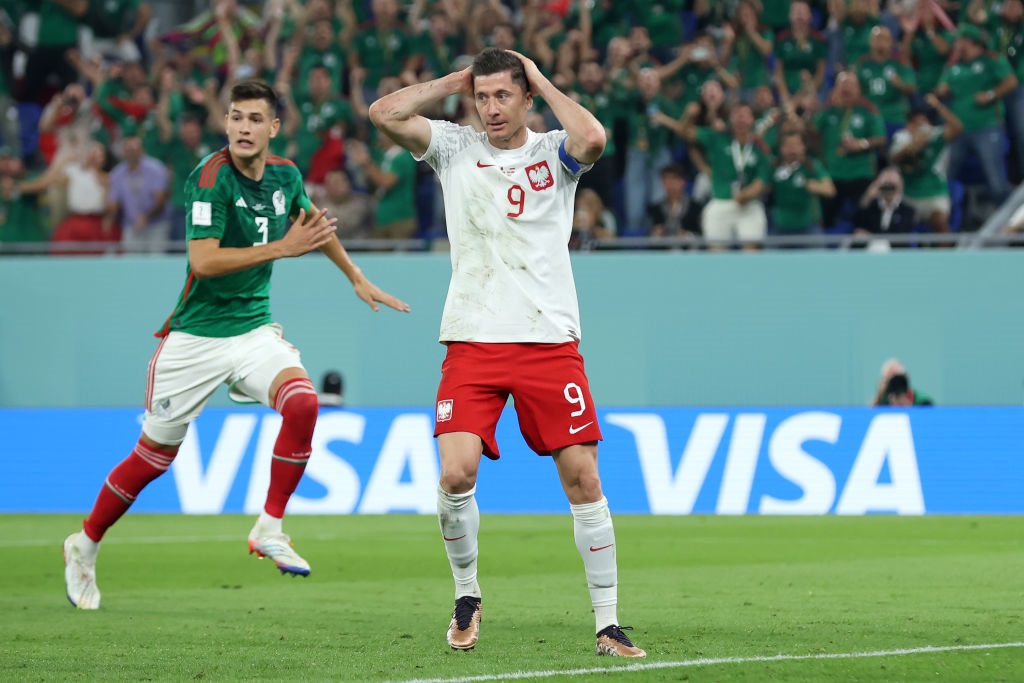 DOHA, QATAR - NOVEMBER 22: Robert Lewandowski of Poland reacts after their penalty was saved by Guillermo Ochoa of Mexico (not pictured) during the FIFA World Cup Qatar 2022 Group C match between Mexico and Poland at Stadium 974 on November 22, 2022 in Doha, Qatar. (Photo by Alex Grimm/Getty Images)