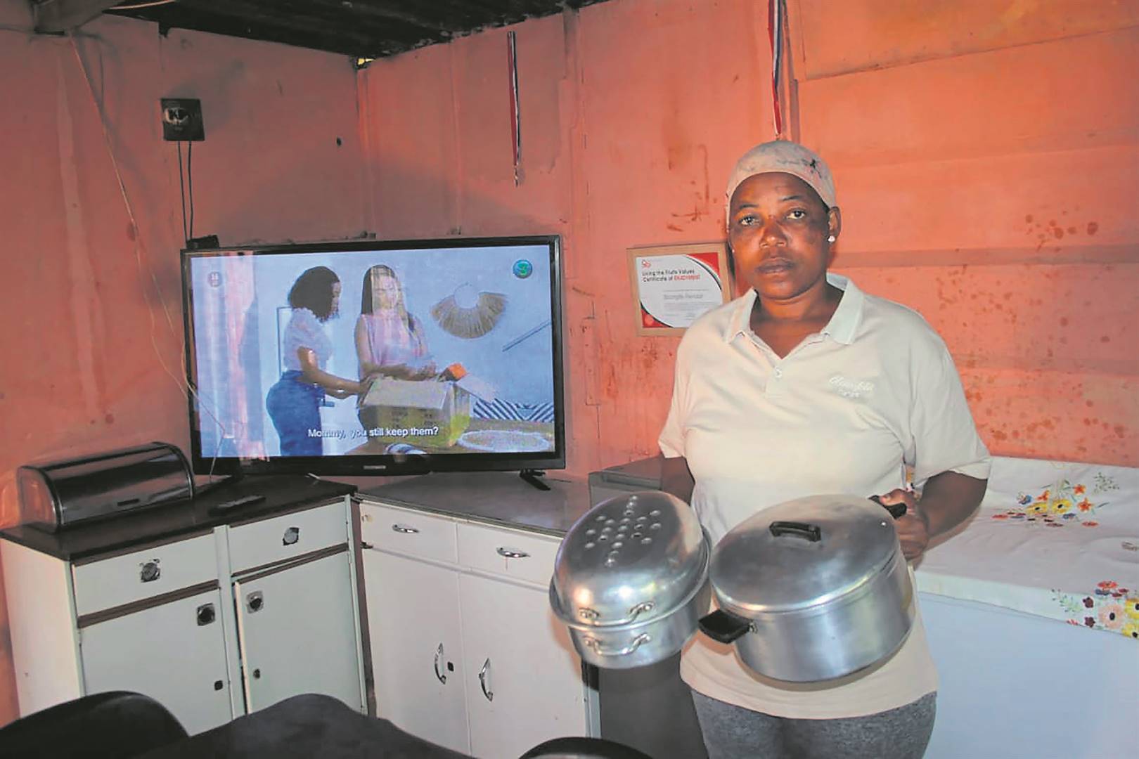 Sibongile Mthembu got some of her stolen pots and TV back after the thug led residents to a scrapyard where he sold the goods. Photo by Phineas Khoza