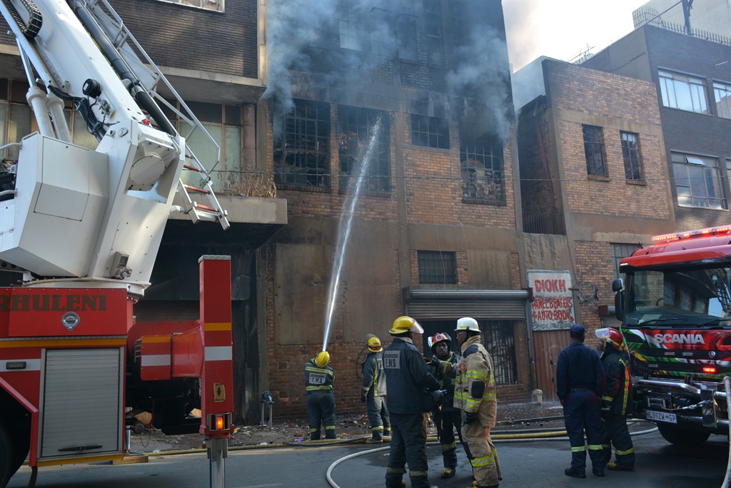 Firefighters put out a fire in one of the buildings in Joburg CBD. Picture: Zamokuhle Mdluli