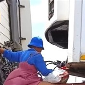 WATCH: Woman caught riding at back of a TRUCK