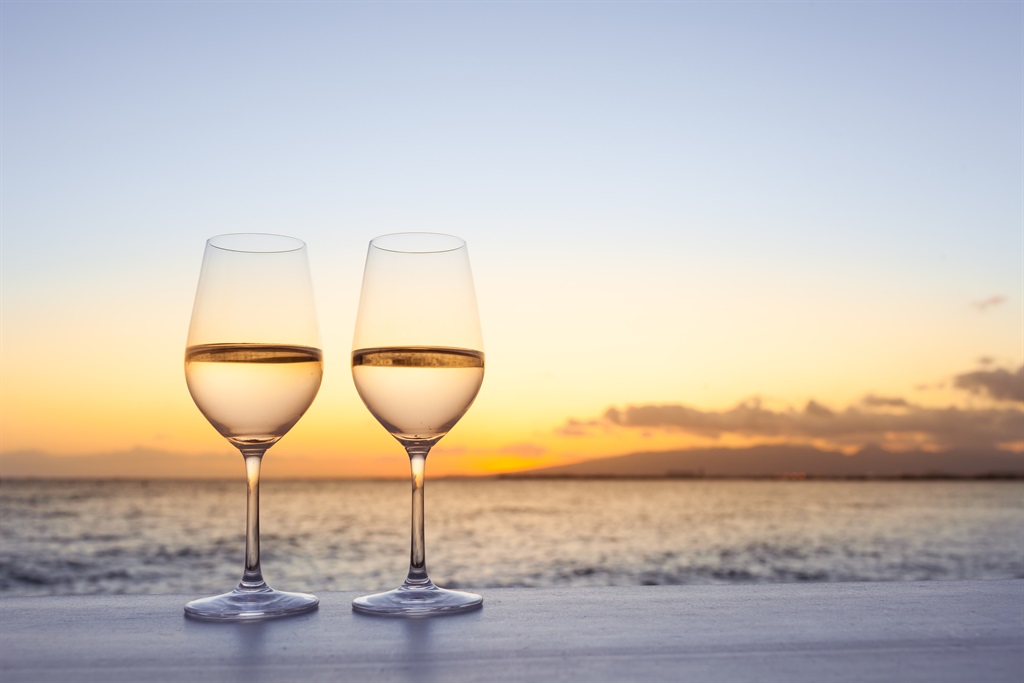 Pair of wine glasses on the beach.