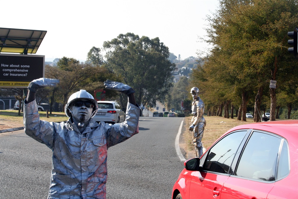Image of a man dressed as a robot directing traffi