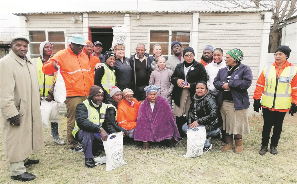 Members of the Thabong CPF, the police and representatives from Goldfields Rotary Club handed out blankets and food to needy families on Friday.               