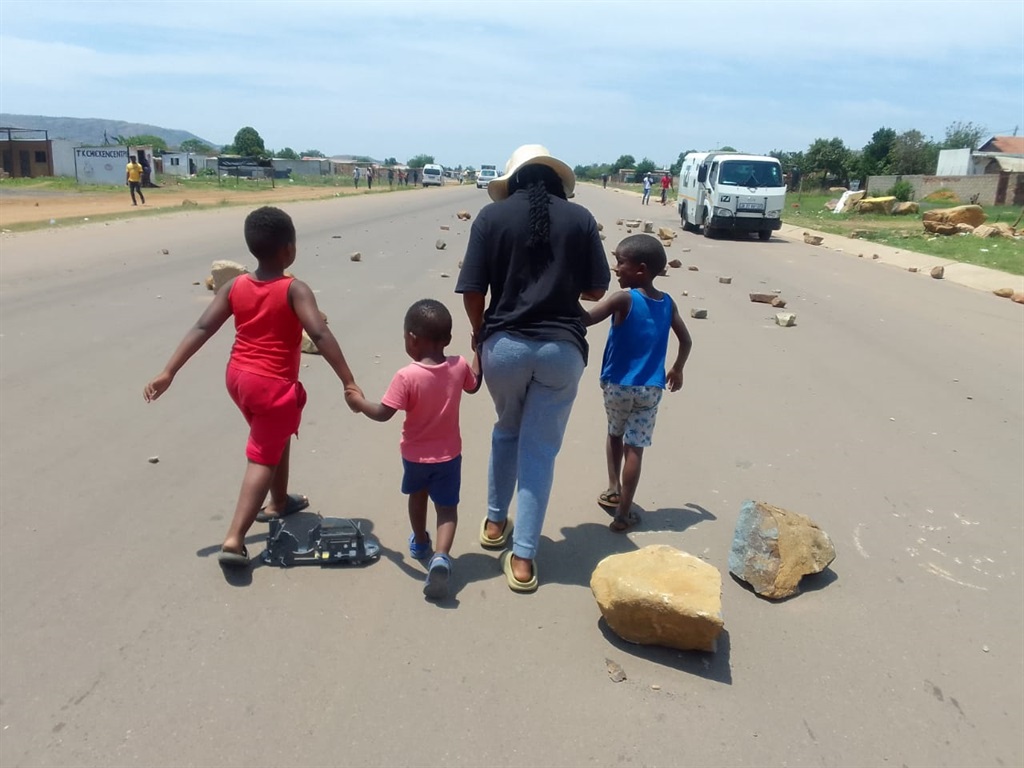 Angry residents of Mamelodi barricaded a road with stones, bricks and logs after a woman walking with children on the side road was hit and killed by a car. Photo:  Raymond Morare