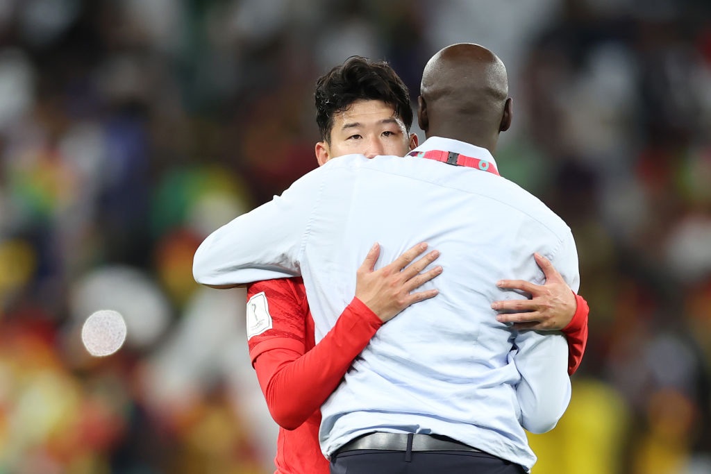 Heung-Min Son of Korea Republic is embraced by Otto Addo, Head Coach of Ghana (Photo by Alex Grimm/Getty Images)