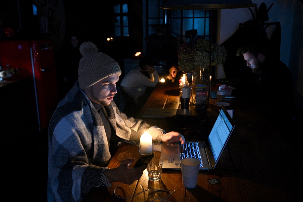 People rest in a coffee shop in Lviv as the city l