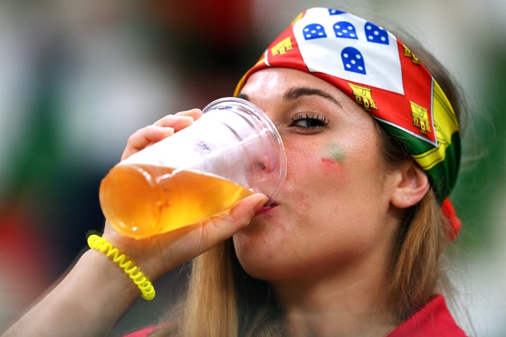 A fan takes a drink during the World Cup match between Portugal and Uruguay at Lusail Stadium, Qatar. Photo: Laurence Griffiths/Getty Images