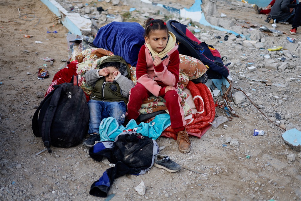 Children rest outside, as Palestinians arrive in Rafah after they were evacuated from Nasser hospital in Khan Younis due to the Israeli ground offensive amid its ongoing war with Hamas in the Gaza Strip.     