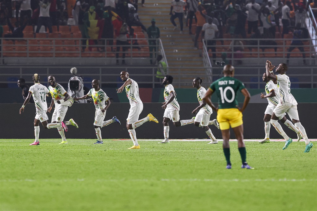 Mali's forward #25 Lassine Sinayoko celebrates with teammates after scoring his team's second goal during the Africa Cup of Nations (CAN) 2024 group E football match between Mali and South Africa at Amadou Gon Coulibaly Stadium in Korhogo on January 16, 2024.