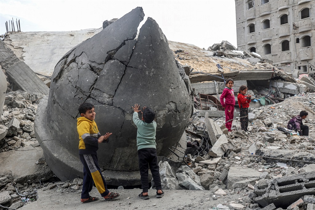 Children play in the rubble of Al-Faruq Mosque, which was destroyed during Israeli bombardment, in Rafah in the southern Gaza Strip on 17 March 2024, amid ongoing battles between Israel and the Palestinian militant group Hamas. (Said Khatib  / AFP)