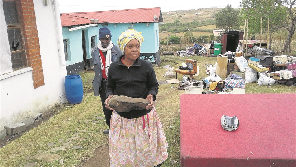 Nofenitshala (front) and Zongezile Adonisi with a rock thrown at her.        Photo by Mbulelo Sisulu