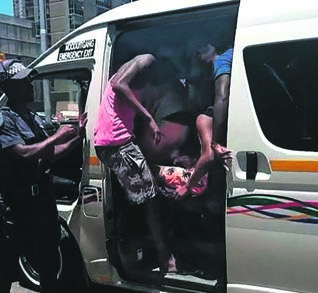 A screengrab of a video which shows people getting off an overloaded taxi.