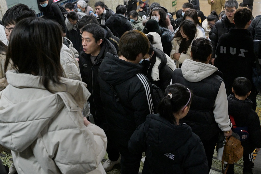 People are seen at a subway station in Beijing on 17 January 2024. China's population decline accelerated in 2023, official data showed.