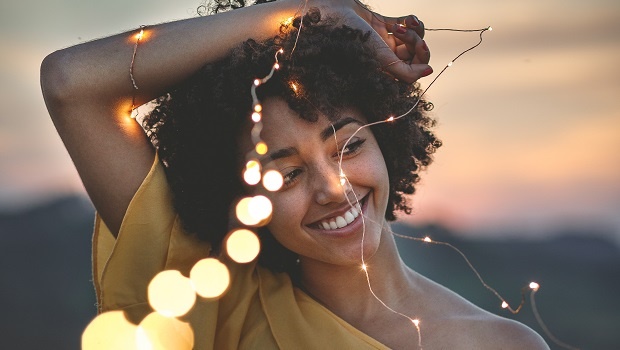 Woman smiling with fairy lights