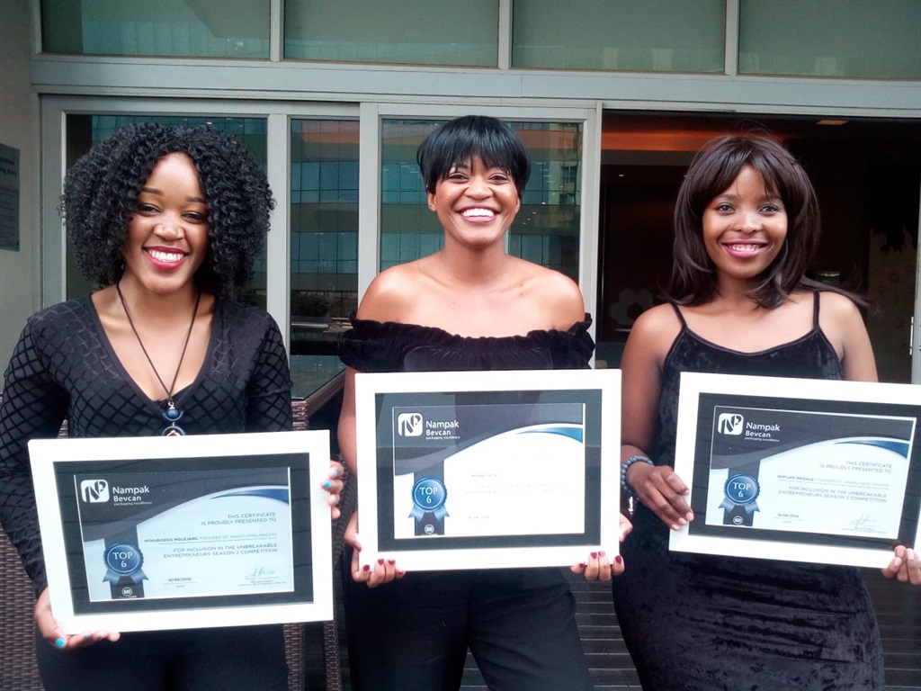 From left: Nthabiseng Molejane, Mannini Setai and Refilwe Mogale, the owners and partners of Ahang Amalmagate Construction, with their competition trophies.             Photo by Malereko Tae