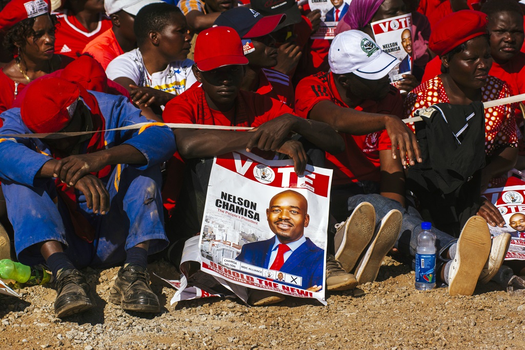 A supporter holds a placard showing Nelson Chamisa, leader of the Movement for Democratic Change (MDC), during a campaign rally in Harare, Zimbabwe, on (July 28, 2018). Picture: Waldo Swiegers/Bloomberg via Getty Images