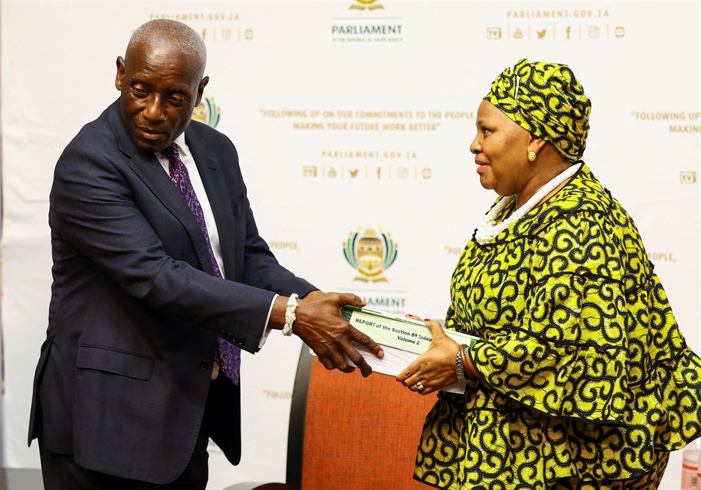 South Africa's former Chief Justice Sandile Ngcobo hands over the report to the Speaker of Parliament, Nosiviwe Mapisa-Nqakula, on whether or not President Cyril Ramaphosa should face an impeachment inquiry over the Phala Phala saga in Cape Town on November 30 2022. Photo: Reuters/Esa Alexander