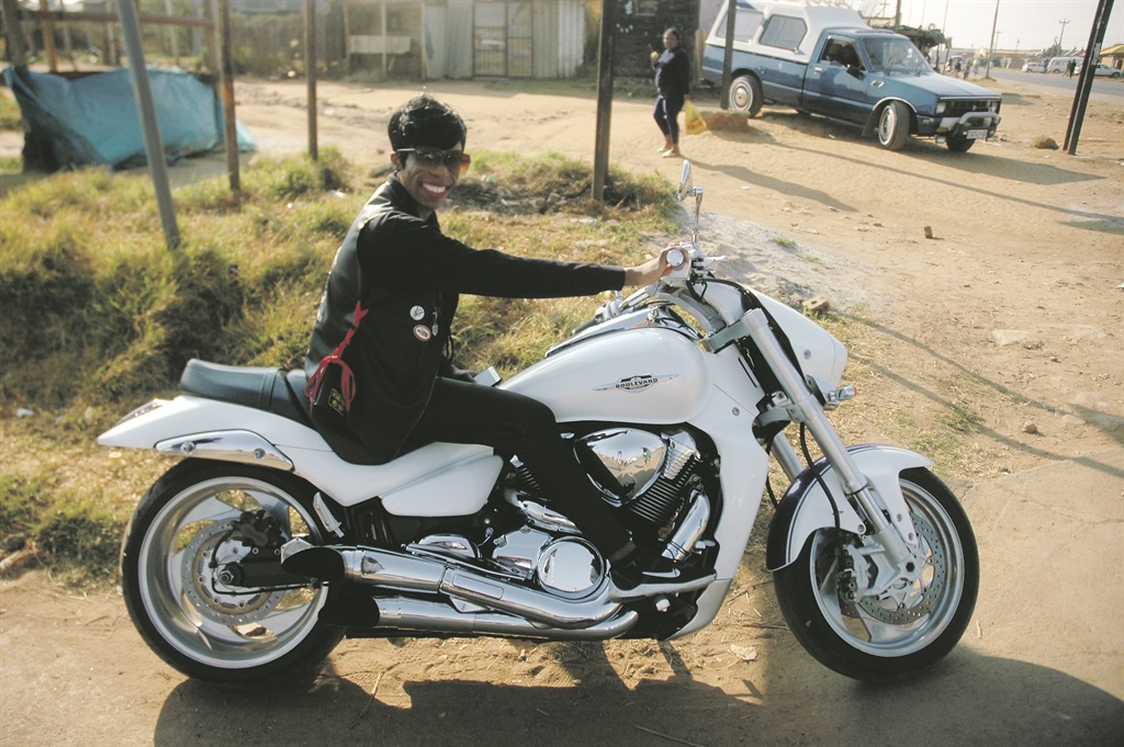 Kerin Mthimkhulu loves the snow white and shiny silver Suzuki Boulevard she calls Angel.           Photo by Phineas Khoza