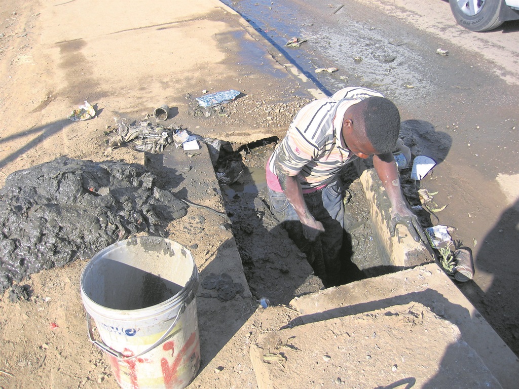 Pedro Mahlangu cleans the stormwater drain in his township once a week.                                Photo by Stephens Molobi