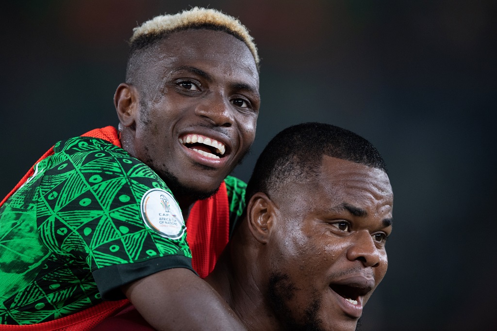 ABIDJAN, IVORY COAST - FEBRUARY 2:  STANLEY BOBO NWABALI of Nigeria carries Victor Osimhen as they celebrate victory in the TotalEnergies CAF Africa Cup of Nations quarterfinal match between Nigeria and Angola at Stade Felix Houphouet Boigny on February 2, 2024 in Abidjan, Ivory Coast. (Photo by Visionhaus/Getty Images)
