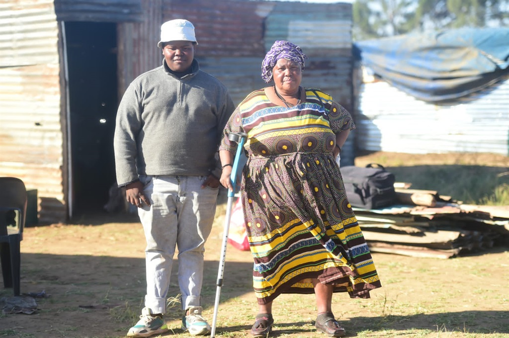 Khethiwe Mayaba and her son Siyabonga Mayaba are relieved after being moved to a better area. Photo by Raymond Morare 