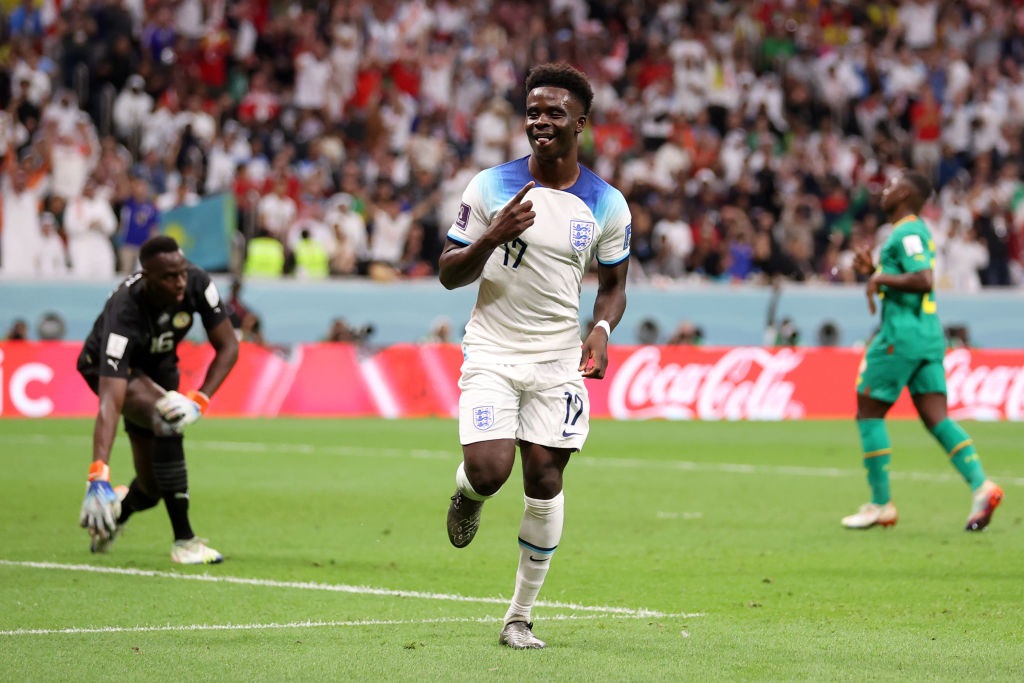 AL KHOR, QATAR - DECEMBER 04: Bukayo Saka of England celebrates after scoring the teams third goal during the FIFA World Cup Qatar 2022 Round of 16 match between England and Senegal at Al Bayt Stadium on December 04, 2022 in Al Khor, Qatar. (Photo by Catherine Ivill/Getty Images)