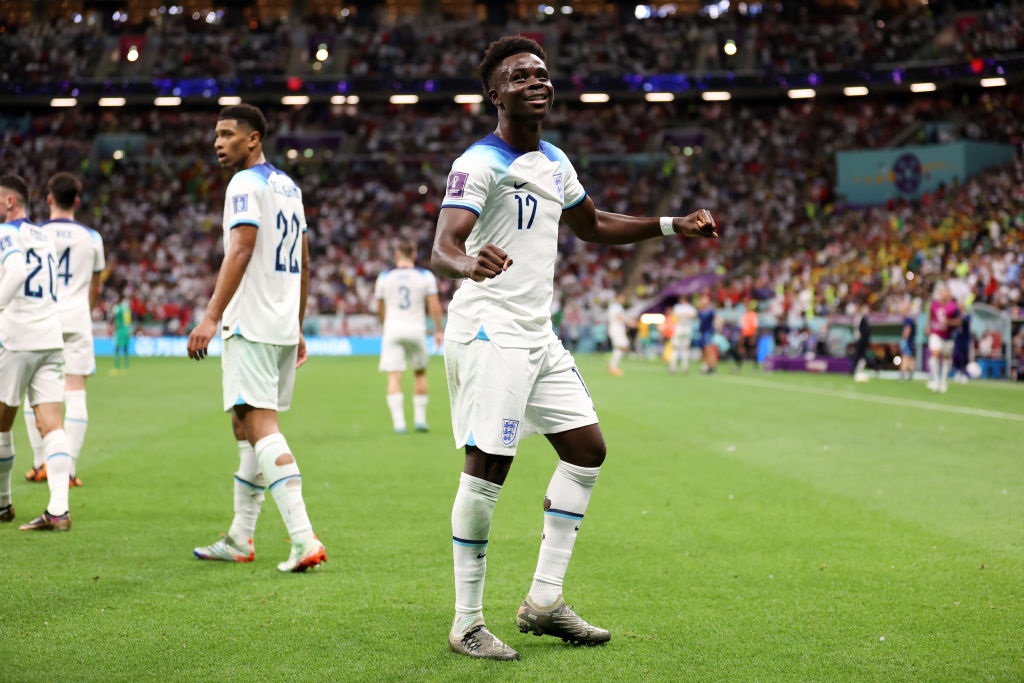 AL KHOR, QATAR - DECEMBER 04: Bukayo Saka of England celebrates after scoring the teams third goal during the FIFA World Cup Qatar 2022 Round of 16 match between England and Senegal at Al Bayt Stadium on December 04, 2022 in Al Khor, Qatar. (Photo by Catherine Ivill/Getty Images)
