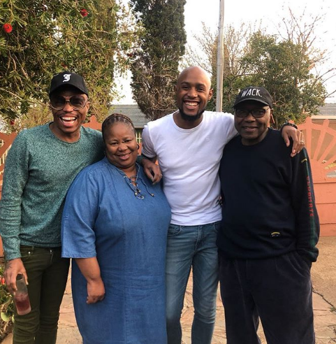 Somizi posing happily with Mohale and his family. Photo: Instagram 