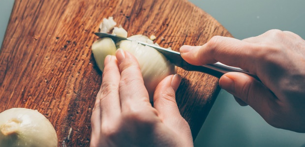 chopping onion on board