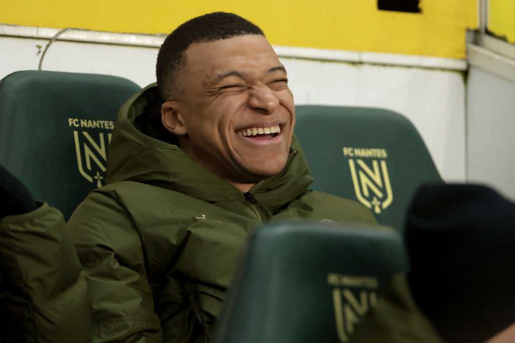 NANTES, FRANCE - FEBRUARY 17: Kylian Mbappe of PSG laughs when sitting on the bench during the Ligue 1 Uber Eats match between FC Nantes (FCN) and Paris Saint-Germain (PSG) at Stade de la Beaujoire on February 17, 2024 in Nantes, France. (Photo by Jean Catuffe/Getty Images)