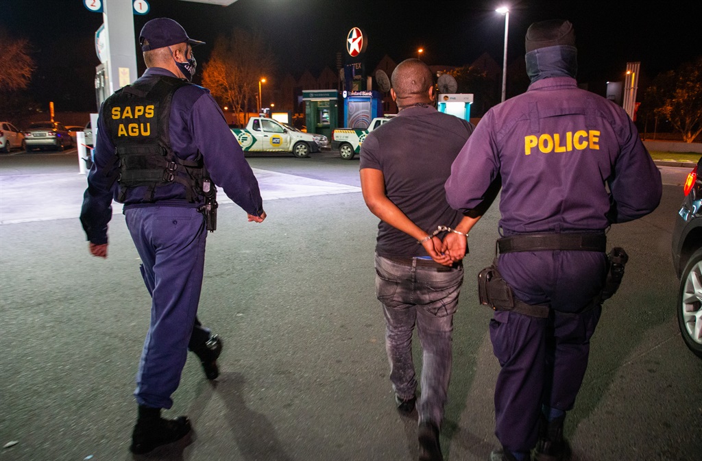SAPS members detain a suspect in Parkhurst, Cape Town.