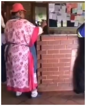 Woman certifies documents at police station.(Photo: Screenshot from video)