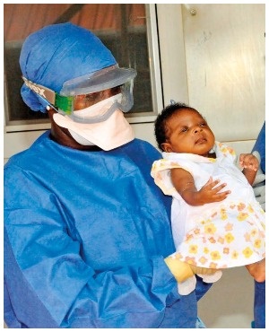 Medical workers with 34-day-old baby Nubia in Guinea in November 2015.