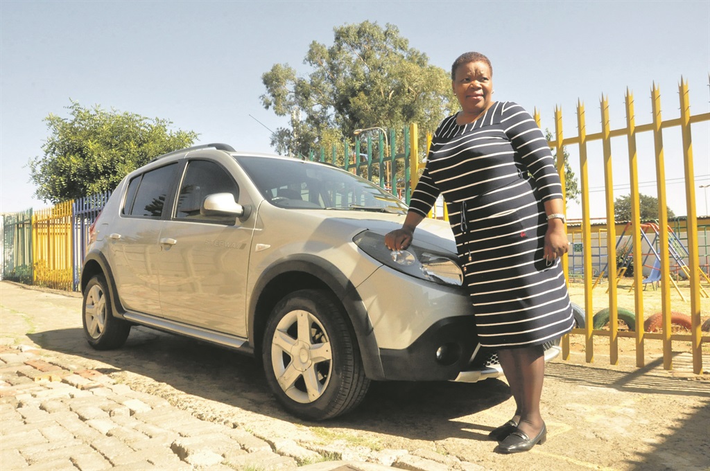 Busisiwe and her lovely little silver car.           Photo by Thabo Monama