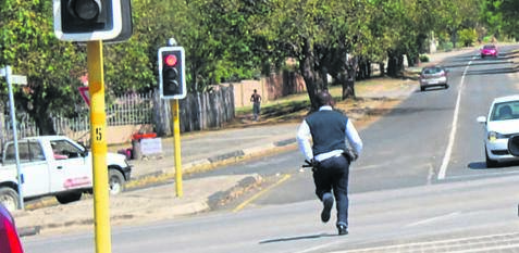 A security guard runs after a mentally ill man who escaped from Rob Ferreira Hospital.
