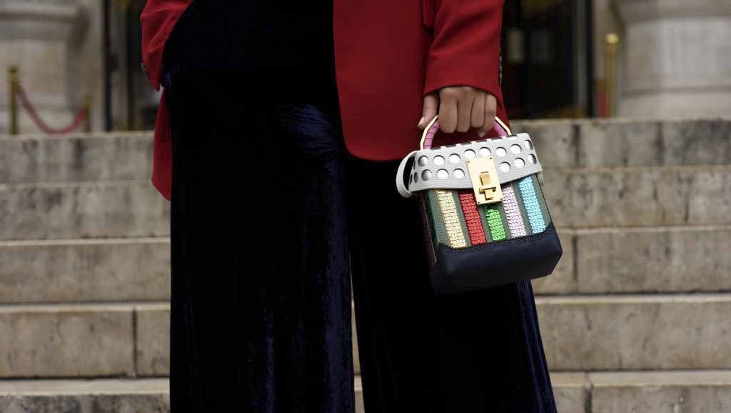 A woman carries her investment 'It' bag