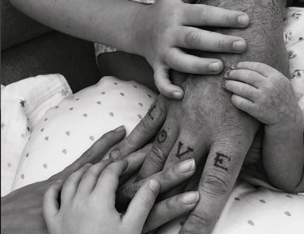 Welcome! The Instagram post announcing Robbie and Ayda Field Williams' third baby together, via surrogacy, shows the hands of Robbie, Ayda, their two bigger children and newborn Coco.