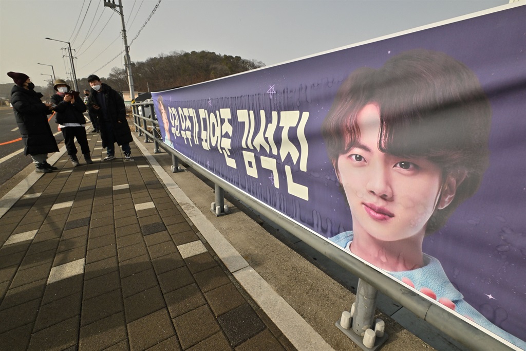 A banner welcoming BTS singer Jin is seen in front