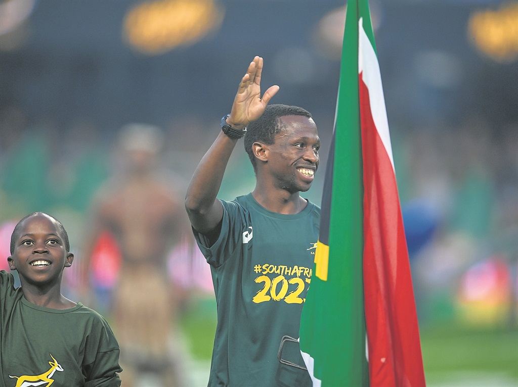 Bongmusa Mthembu, who again represented the country well at the IAU 100km Championship in Croatia, waves at the crowds with a young fan by his side.Photo by GalloImages